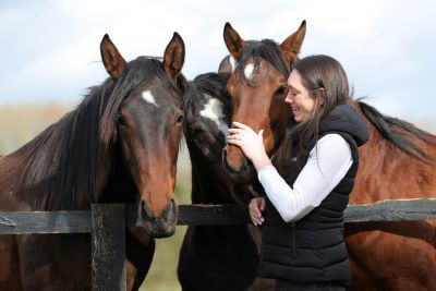 three Feedmark horses with Stephanie Hyland, Feedmark's Registered Nutritionist